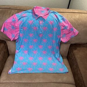 Chubbies performance polo shirt featuring a blue and pink palm tree print